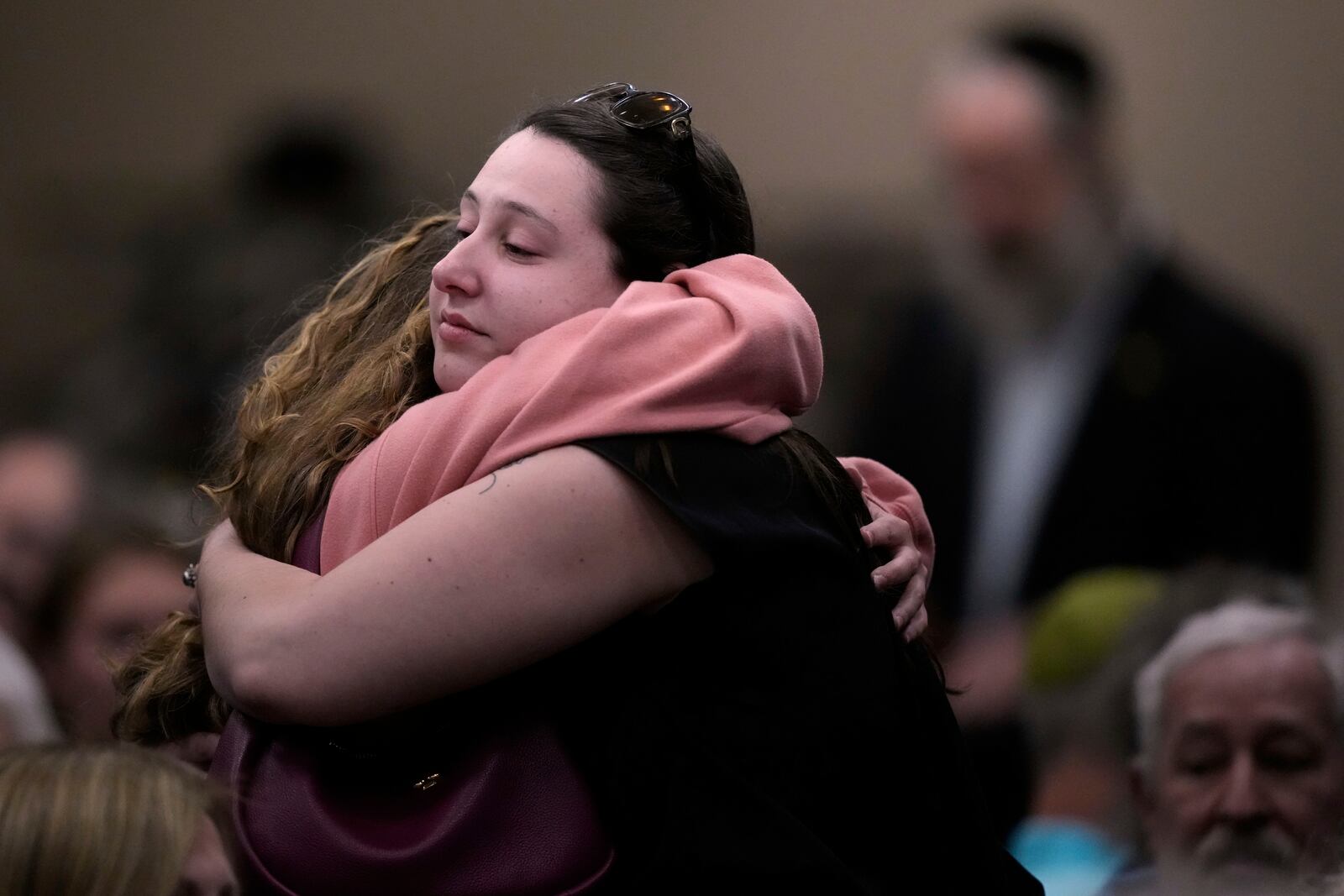People at the Jewish Community Center of Greater Kansas City morn Sarah Milgrim and Yaron Lischinsky, Israeli Embassy staff members who were shot and killed while leaving an event at a Jewish museum in Washington, Thursday, May 22, 2025, in Overland Park, Kan. (AP Photo/Charlie Riedel)