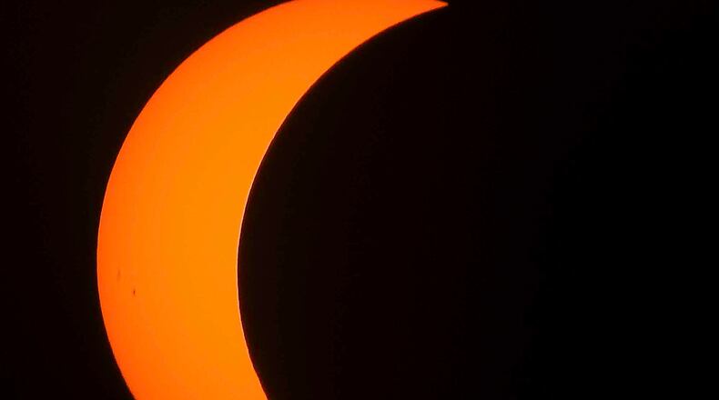 The eclipse was visible through special solar filters and glasses Monday, Aug. 21, 2017, in West Chester Township. NICK GRAHAM/STAFF
