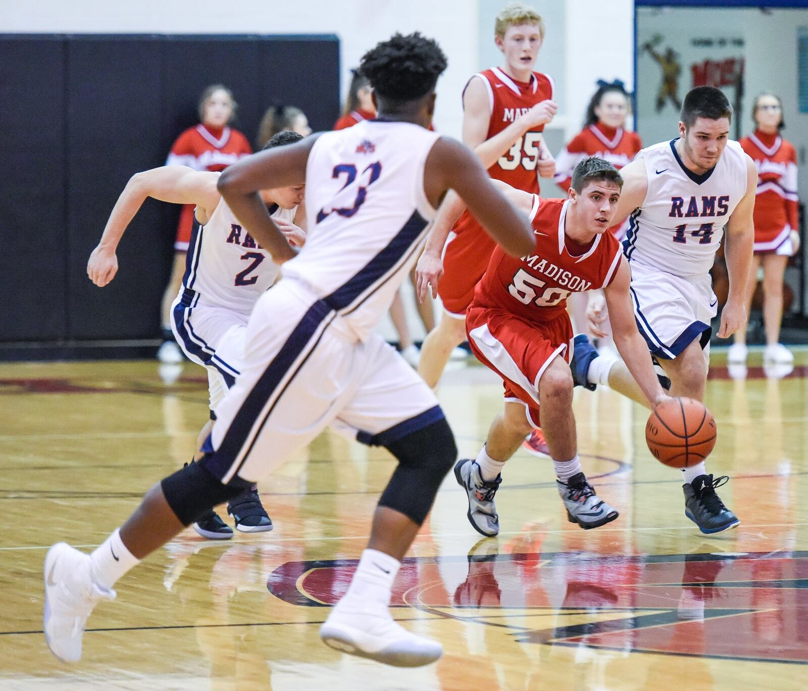 Madison’s Tyler Baumgartner dribbles up the court between Miami Valley’s Lennox Roberts (23), Chase Harlan (2) and Charlie Lyon (14) during Thursday’s game in the Brian Cook Classic at Madison. NICK GRAHAM/STAFF