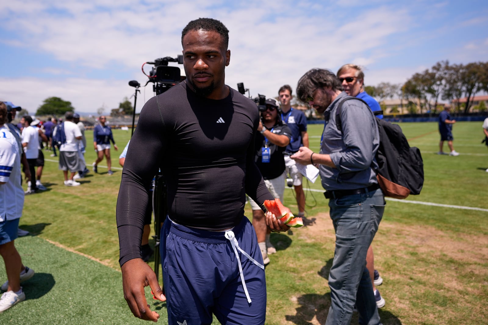Dallas Cowboys defensive end Micah Parsons walks off the field after speaking to reporters after training camp Tuesday, July 22, 2025, in Oxnard, Calif. (AP Photo/Mark J. Terrill)