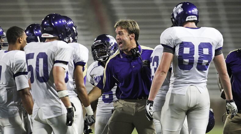 Middletown head football coach Troy Everhart (center) gets fired up during a Crosstown Showdown game on Aug. 24, 2012, against St. Xavier at the University of Cincinnati’s Nippert Stadium. Everhart resigned as head coach Wednesday.