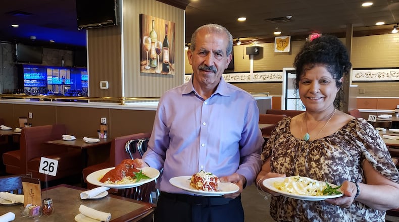 Spinning Forchetta owner George Shteiwi and his sister Laila Alghanim display Spaghetti & Meatballs, Fettuccine Alfredo and Mama Nella s Lasagna, the three most popular dishes at the Italian eatery in Liberty Twp.. Formerly known as the Spinning Fork, it relocated from Fairfield and changed its name. ERIC SCHWARTZBERG/STAFF
