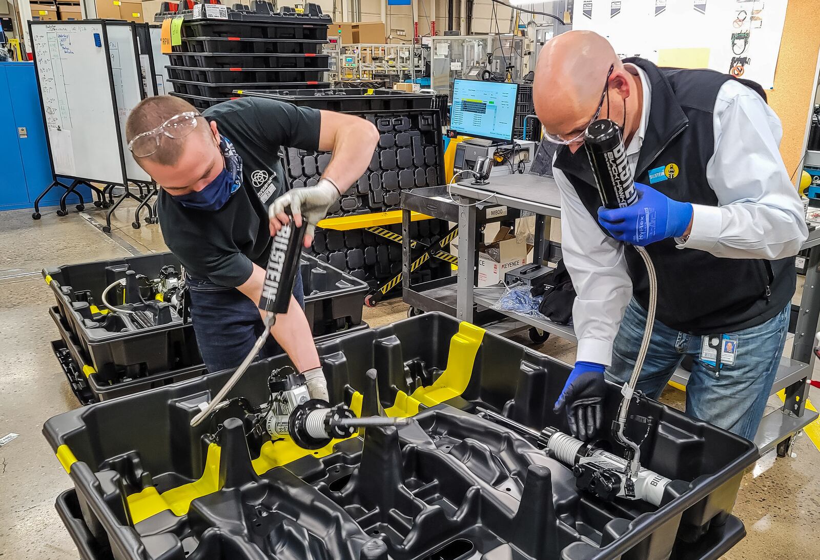 Fabian Schmahl, right, President and CEO of thyssenkrupp Bilstein of America, Inc., and Aiden Lewis, show suspension components for the new Ram TRX pickup during a tour of the facility Tuesday, November 24, 2020 in Hamilton. NICK GRAHAM / STAFF