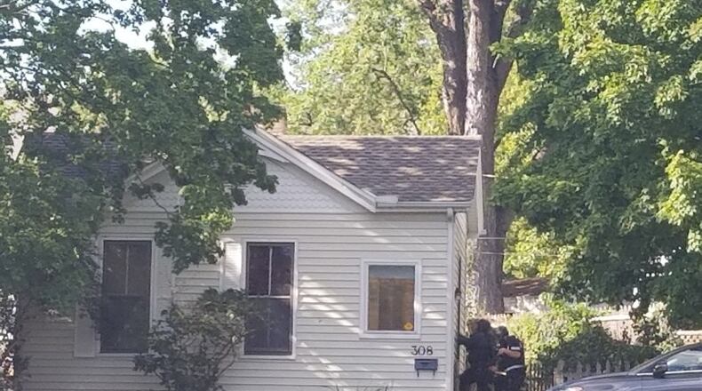 A SWAT team surrounds a house in the 300 block of Wayne Avenue on Wednesday. MICHAEL PURVES/STAFF