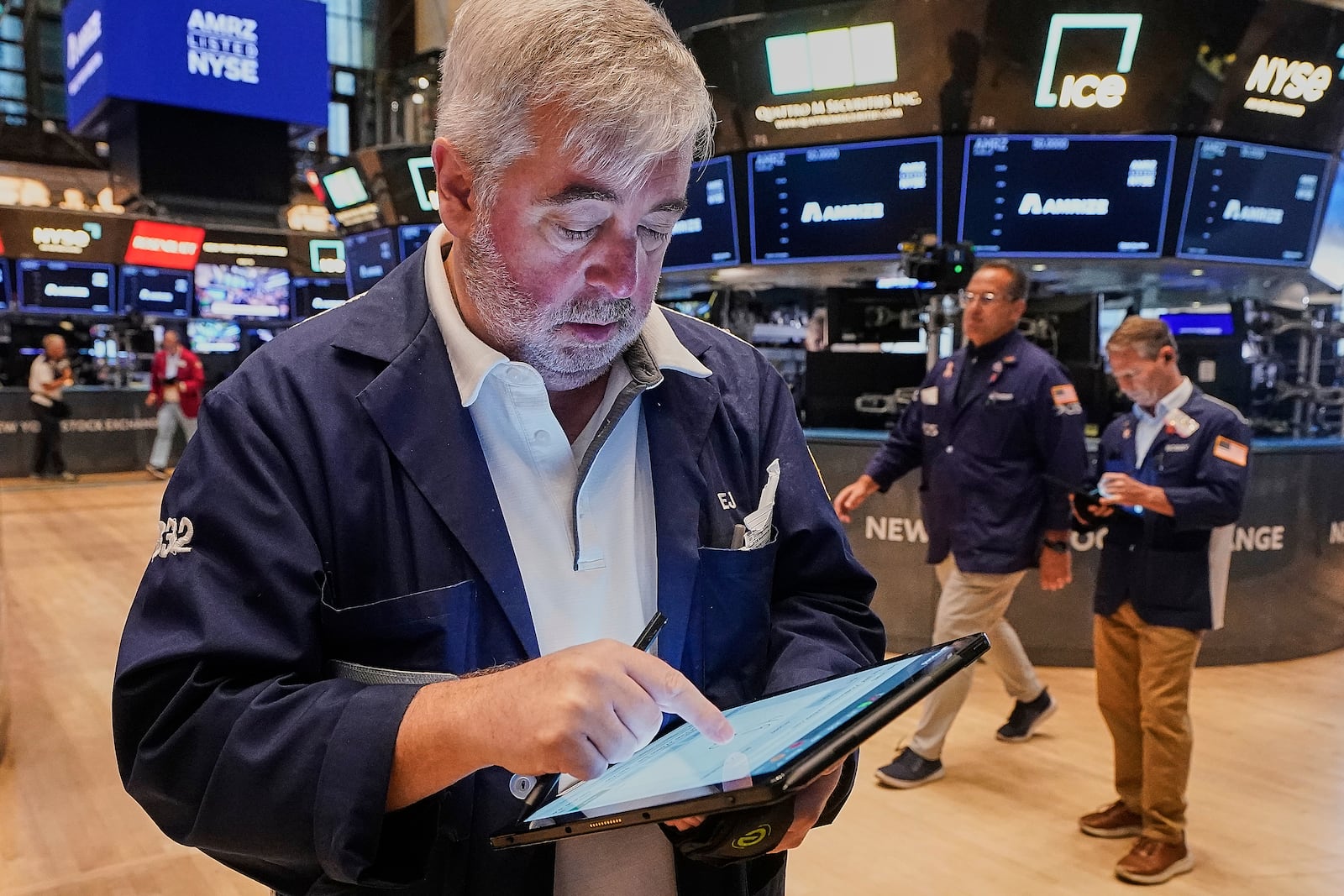 Trader Edward McCarthy, left, works on the floor of the New York Stock Exchange, Monday, June 23, 2025. (AP Photo/Richard Drew)