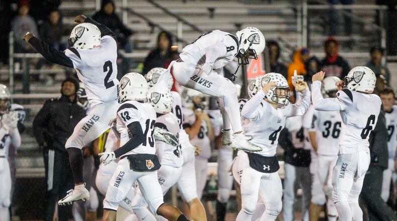 The Lakota East Thunderhawks show their joy after defeating host Mason 20-17 in a Division I, Region 4 playoff opener at Dwire Field in Mason on Friday night. NICK GRAHAM/STAFF