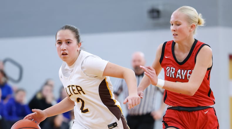 Alter senior guard Izzie Arcuri dribbles ahead of Cincinnati Indian Hill's Maddy Harris during a Division IV district final on Saturday, Feb. 28 at Troy High School's Trojan Activities Center. BRYANT BILLING / STAFF
