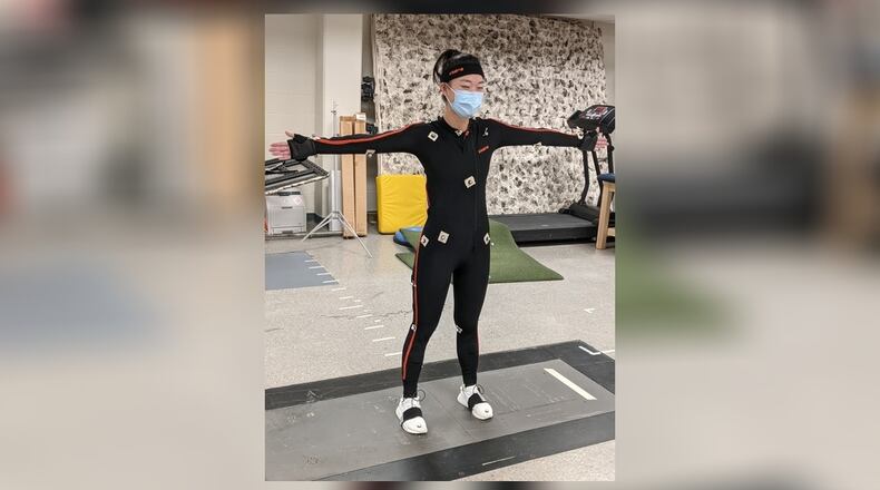Tess McGuire, testing the golf swing marker set software, completed her master’s thesis on the golf swing and graduated from Miami in May. CONTRIBUTED