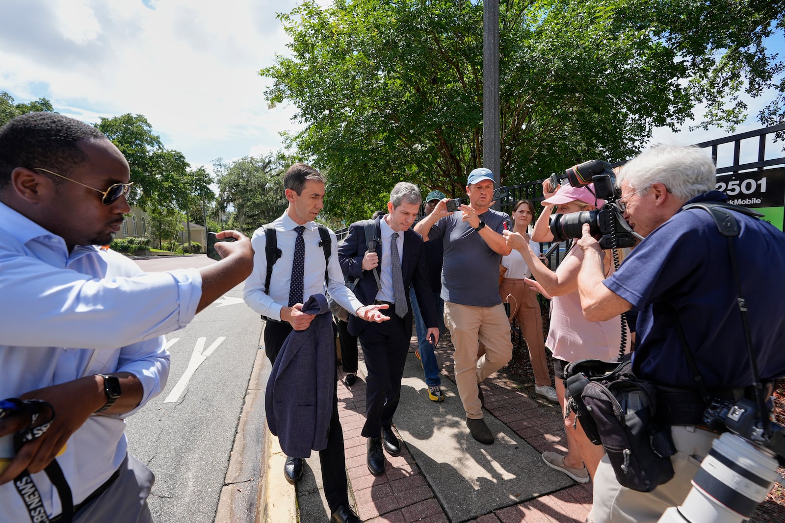 David Oscar Markus, attorney for Ghislaine Maxwell, center, is questioned by the media outside the federal courthouse in Tallahassee, Fla., Thursday, July 24, 2025. (AP Photo/John Raoux)