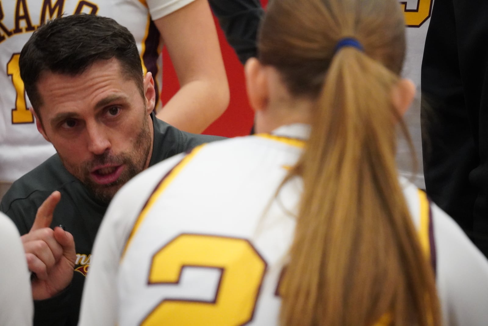 Ross girls basketball coach Ben Buehner talks to his team during a timeout against Goshen on Tuesday night at Princeton. CHRIS VOGT / CONTRIBUTED