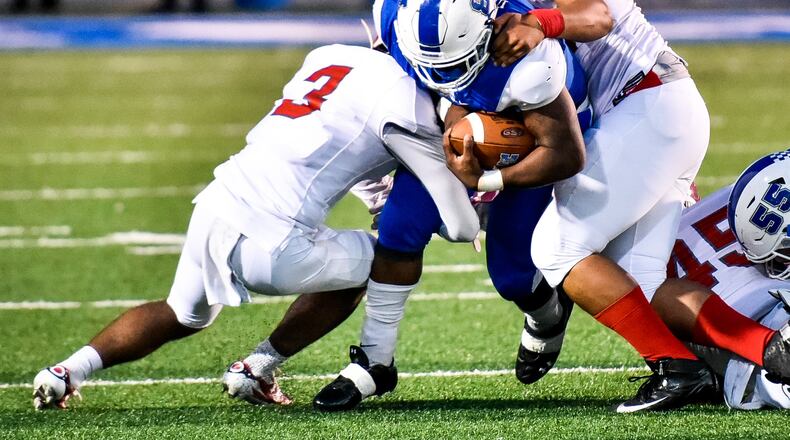 Hamilton’s Maleek Jarrett carries the ball during Friday night’s game against Princeton at Virgil Schwarm Stadium in Hamilton. NICK GRAHAM/STAFF