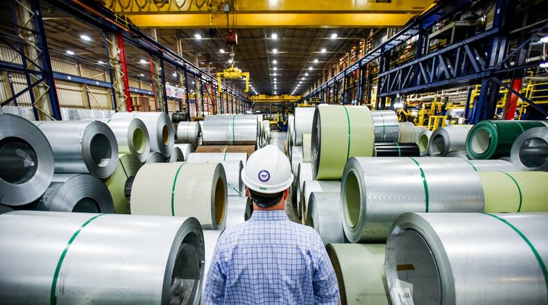 John Wallace, vice president of Quality and Technical Systems at NCI Group, Inc. walks between coils of steel that are lined up and ready to be coated at Metal Coaters Middletown location, a coil coating facility for NCI Building Systems, Oct. 5, 2016. Metal Coaters plans to hire as many as 30 new employees for its Middletown facility by the end of this year. NICK GRAHAM/STAFF FILE PHOTO