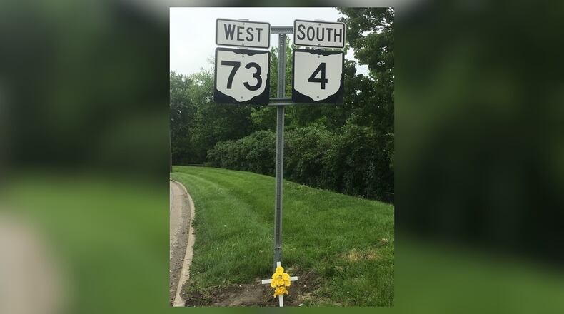 A white cross has been erected on North Verity Park near Hughes Street where a Middletown man was critically injured Saturday night in a two-vehicle accident. RICK McCRABB/STAFF
