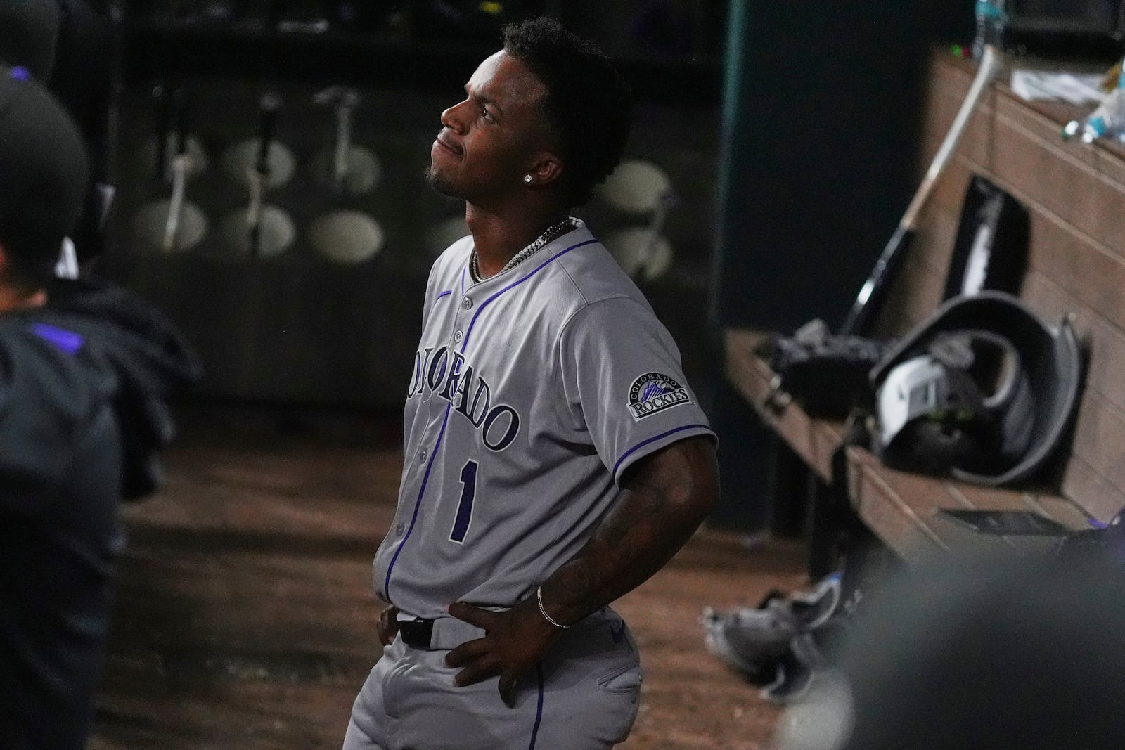 Colorado Rockies' Adael Amador stands in the dugout after lining out to Texas Rangers shortstop Josh Smith during the ninth inning of a baseball game Wednesday, May 14, 2025, in Arlington, Texas. (AP Photo/LM Otero)
