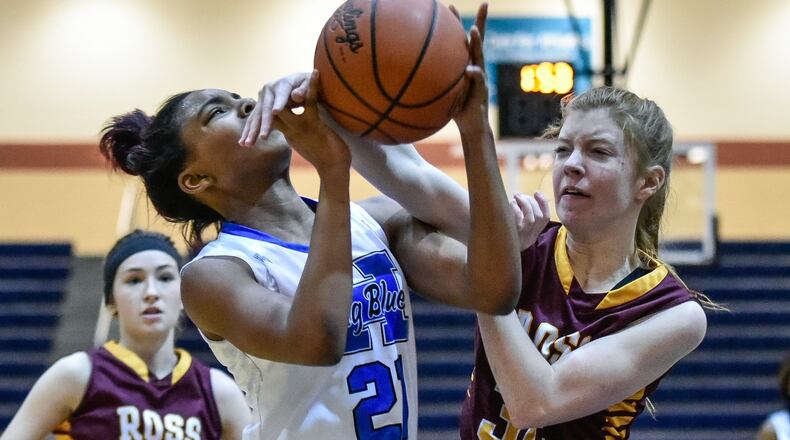 Hamilton’s CiCi Riggins is fouled by Grace Stenger of Ross during Monday night’s game at the Hamilton Athletic Center. NICK GRAHAM/STAFF
