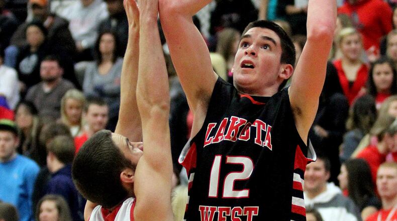 Lakota West center Tyler Bowling scores against Fairfield guard Eric Vinson during a game at the Fairfield Arena on Dec. 28, 2012. JOURNAL-NEWS FILE PHOTO