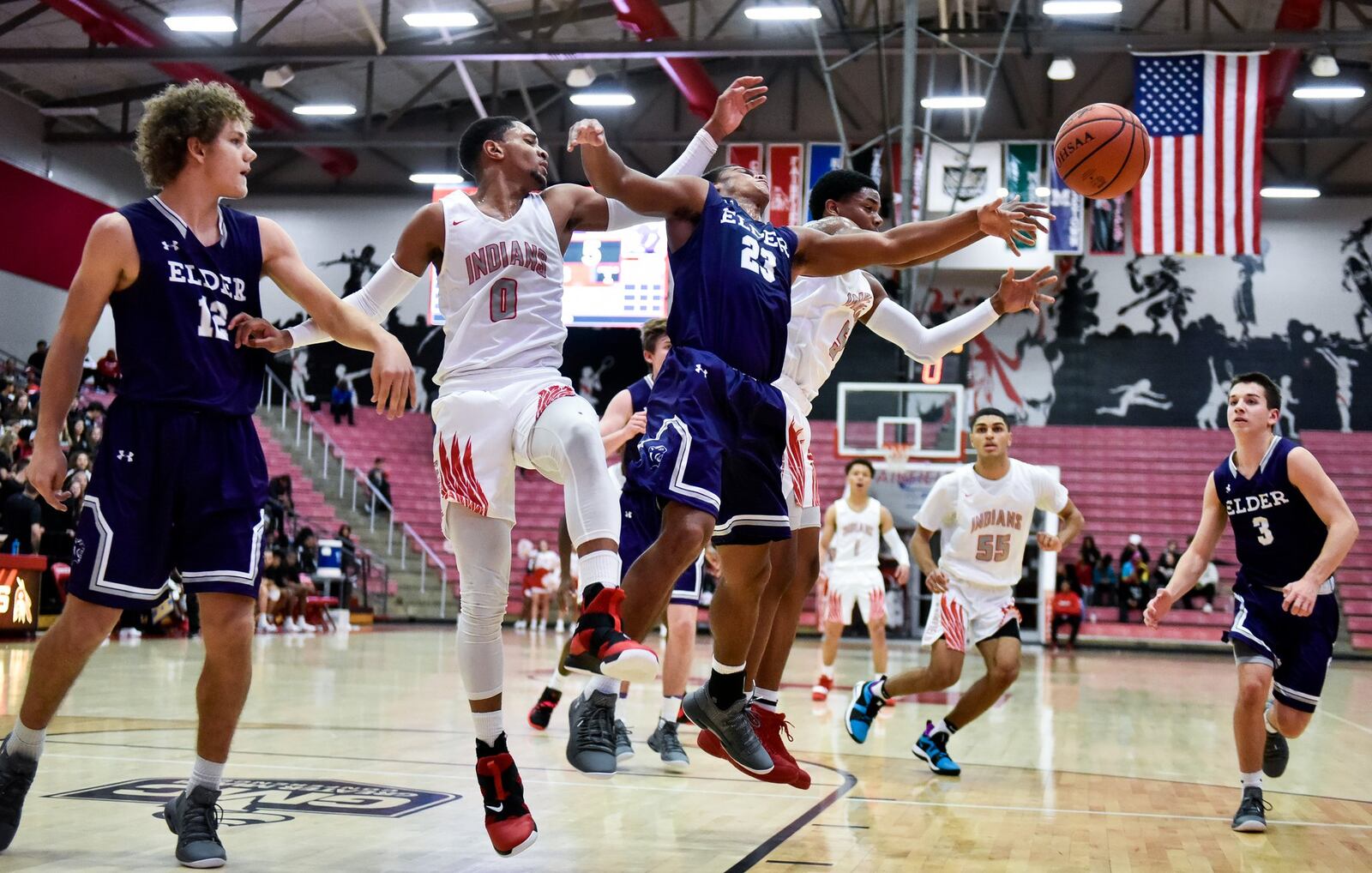 Elder’s Joe Royer (12) and Bryson Merz (23) battle for the ball with Fairfield’s Devin Turner (0) and Caleb Pryce (5) during their Nov. 30 game at the Fairfield Arena. Elder won 62-55. NICK GRAHAM/STAFF