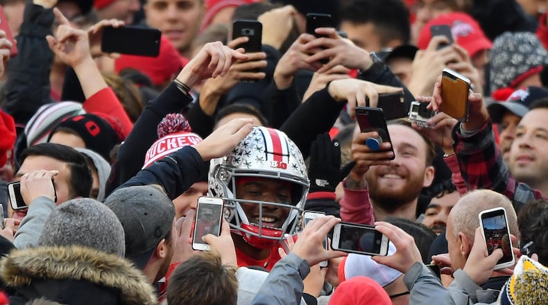 COLUMBUS, OH - NOVEMBER 24:  Quarterback Dwayne Haskins #7 of the Ohio State Buckeyes is congratulated by fans as he walks off the field after defeating the Michigan Wolverines at Ohio Stadium on November 24, 2018 in Columbus, Ohio. Ohio State defeated Michigan 62-39.  (Photo by Jamie Sabau/Getty Images)