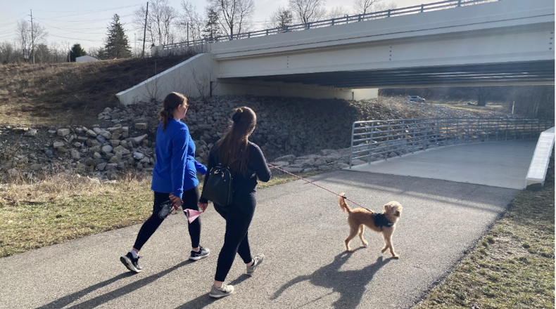 Two people walk their dog on the trail near Peffer Park. EDWARD ORZECH/OXFORD OBSERVER