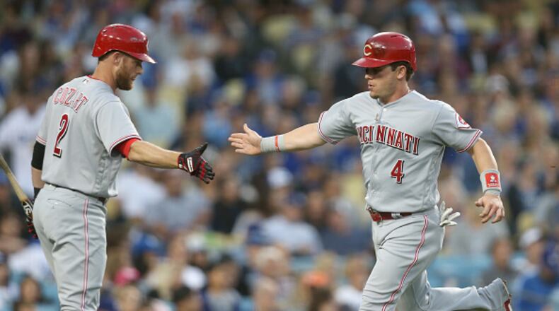 LOS ANGELES, CA - JUNE 10: Scooter Gennett #4 of the Cincinnati Reds is greeted by on deck batter Zack Cozart #2 after scorinig a run in the third inning against the Los Angeles Dodgers at Dodger Stadium on June 10, 2017 in Los Angeles, California. (Photo by Stephen Dunn/Getty Images)