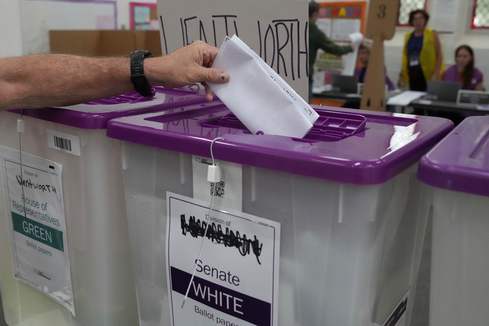 A ballot is dropped into a a box as early voting begins in Sydney, Tuesday, April 22, 2025, for a national election to be held on May 3. (AP Photo/Mark Baker)