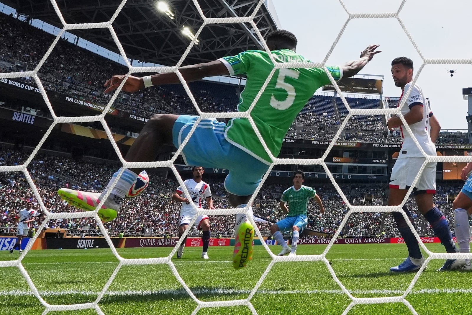 Seattle Sounders' Nouhou Tolo stops a shot by Paris Saint-Germain's Warren Zaire-Emery during the Club World Cup Group B soccer match between Seattle Sounders and PSG in Seattle, Monday, June 23, 2025. (AP Photo/Lindsey Wasson)