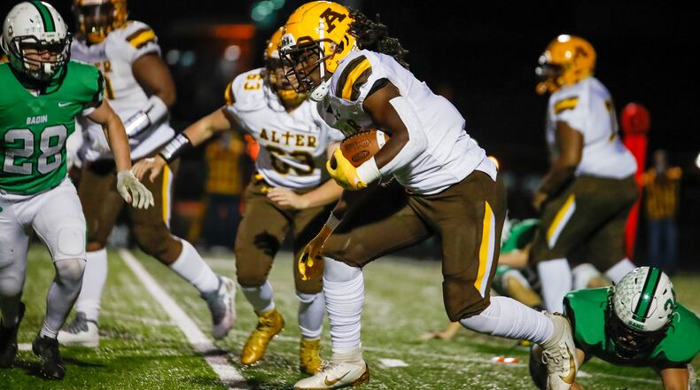Alter High School senior running back Branden McDonald runs through several Hamilton Badin defenders during their game on Friday night at Lakota East. The Knights won 20-3. Michael Cooper/CONTRIBUTED