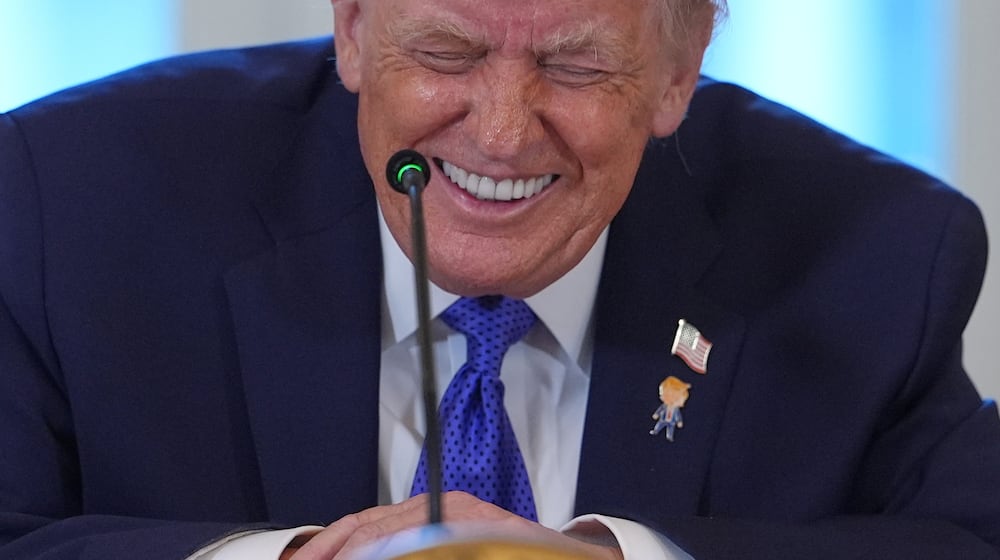 President Donald Trump laughs during a meeting with oil executives in the East Room of the White House, Friday, Jan. 9, 2026, in Washington. (AP Photo/Evan Vucci)