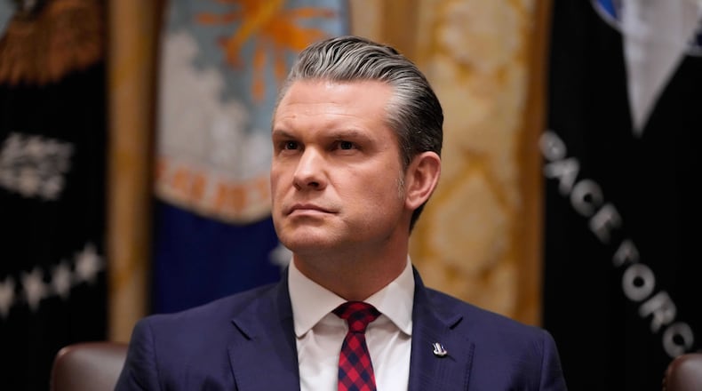 Defense Secretary Pete Hegseth listens as President Donald Trump speaks during a Cabinet meeting at the White House, Tuesday, Dec. 2, 2025, in Washington. (AP Photo/Julia Demaree Nikhinson)