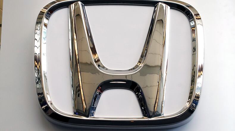 FILE- This Feb. 14, 2019 file photo shows a Honda logo at the 2019 Pittsburgh International Auto Show in Pittsburgh. Honda has plans to sell two all-electric SUVs in the U.S. for the 2024 model year, and it soon will offer hybrid gas-electric versions of its top-selling models. The announcements March 11 come as the automaker acknowledges it has work to do to comply with emissions-reduction targets that will be coming from the Biden administration, and a California ban on sales of new internal-combustion vehicles by 2035. (AP Photo/Gene J. Puskar, File)