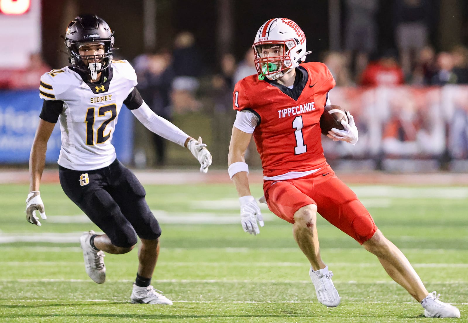 Tippecanoe senior receiver Will Strong runs as Sidney's Dreaden Foy trails during a Miami Valley League game on Thursday, Sept. 25 at Tipp City Park. BRYANT BILLING / STAFF