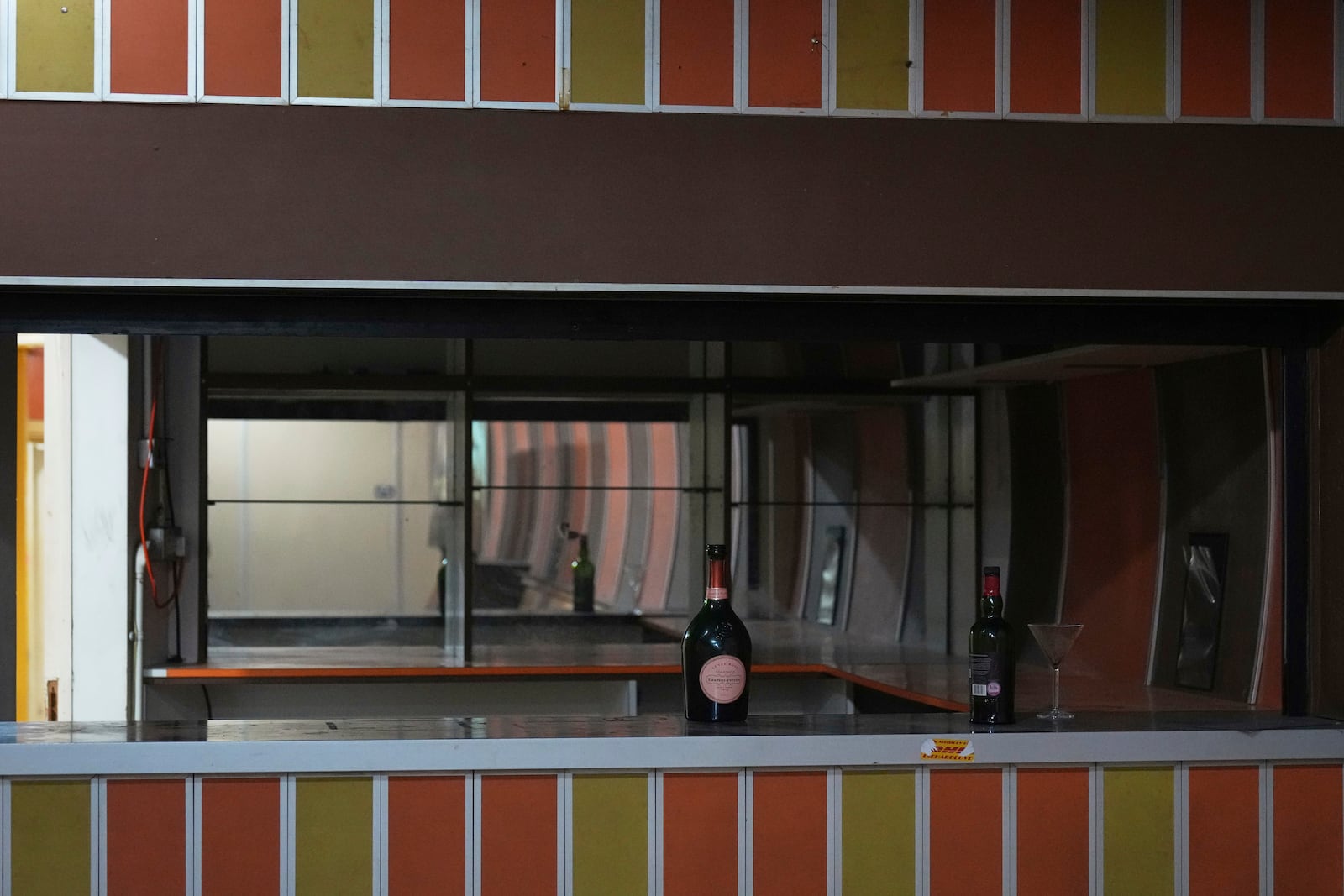 Bottles and glasses left on the counter of one of the bars that operated from the 1980's, are seen during a press tour in London, Thursday, June 19, 2025. (AP Photo/Joanna Chan)