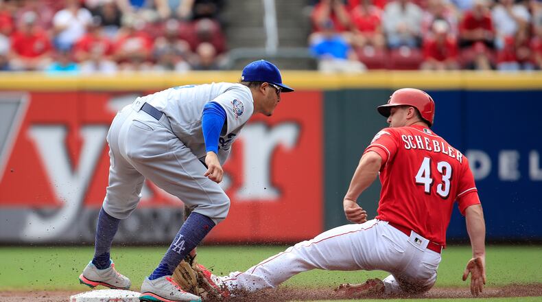 CINCINNATI, OH - SEPTEMBER 12: Manny Machado #8 of the Los Angeles Dodgers tags out Scott Schebler #43 of the Cincinnati Reds as he attempted to steal second base in the first inning at Great American Ball Park on September 12, 2018 in Cincinnati, Ohio. (Photo by Andy Lyons/Getty Images)