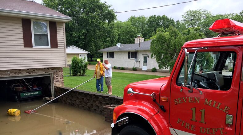 The Seven Mile Fire Department in Butler County was busy Thursday morning pumping water out of homes on Taylor School Road. NICK GRAHAM/STAFF