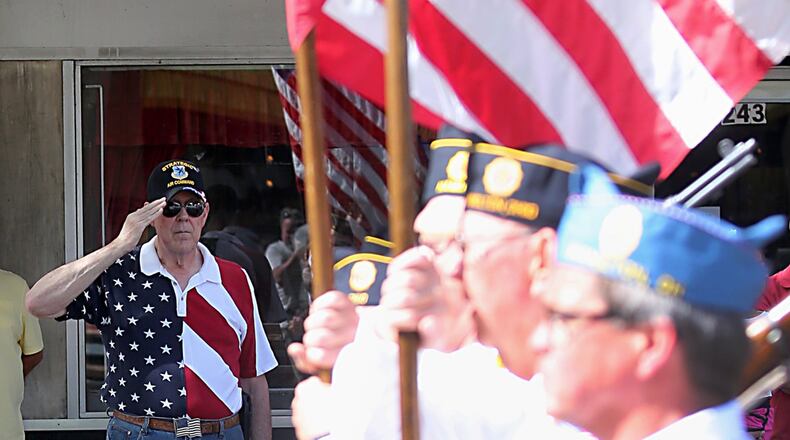 A veteran salutes as an Honor Guard carries the flag past during the 2016 Memorial Day parade in Hamilton.