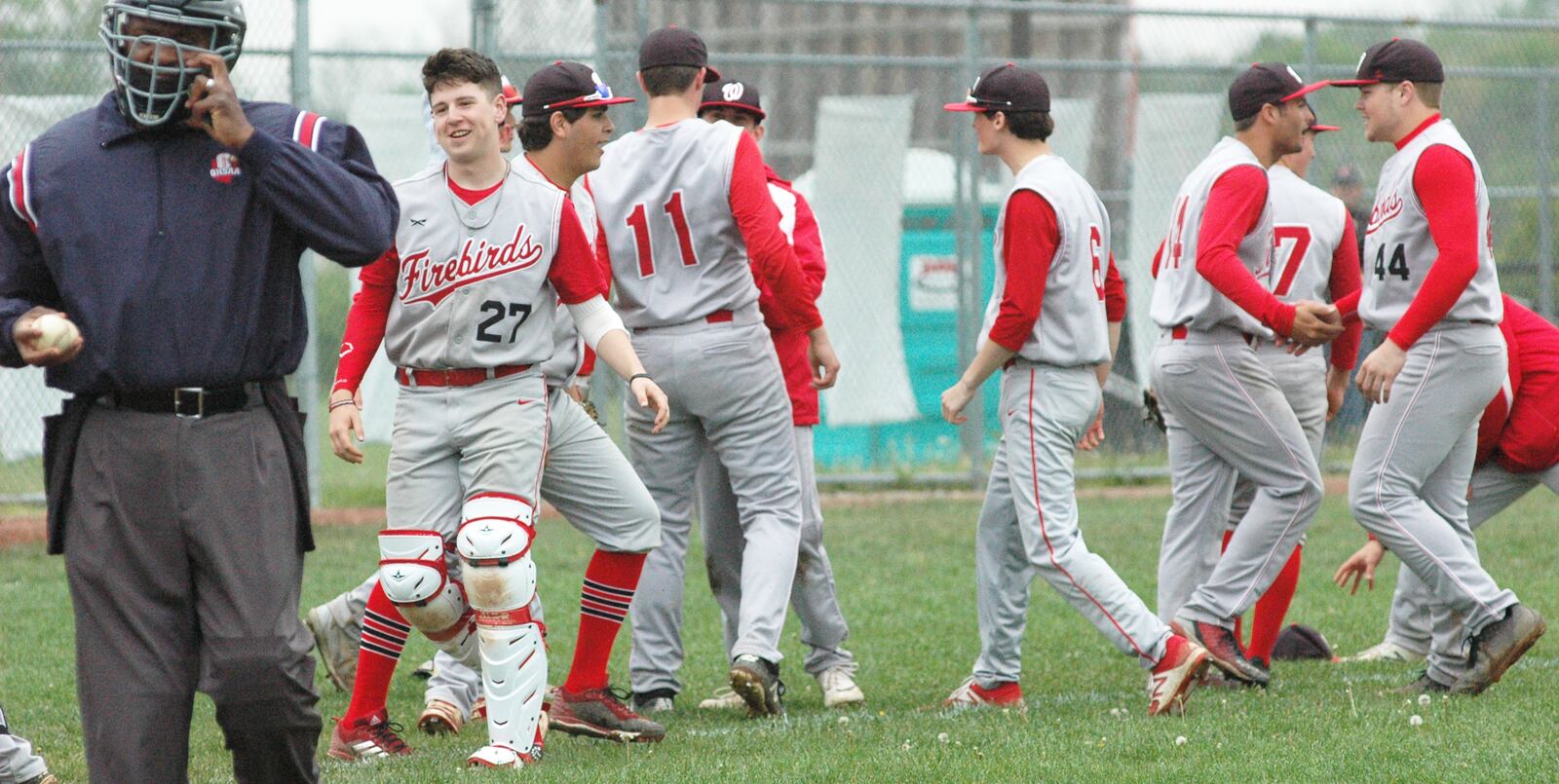 Lakota West’s players celebrate Saturday afternoon after a 5-3, nine-inning Greater Miami Conference baseball victory at Lakota East. RICK CASSANO/STAFF