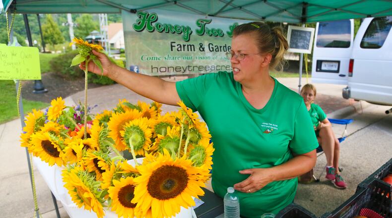 In this 2016 photo, Linda Hebauf and Sara Clevidence of Honey Tree Acres, sell flowers, produce, and herbs during the Fairfield Farmers Market at Village Green. GREG LYNCH / STAFF