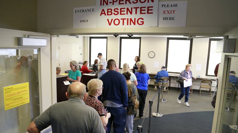 People wait in line to cast their early vote Wednesday at the Clark County Board of Elections. Bill Lackey/Staff