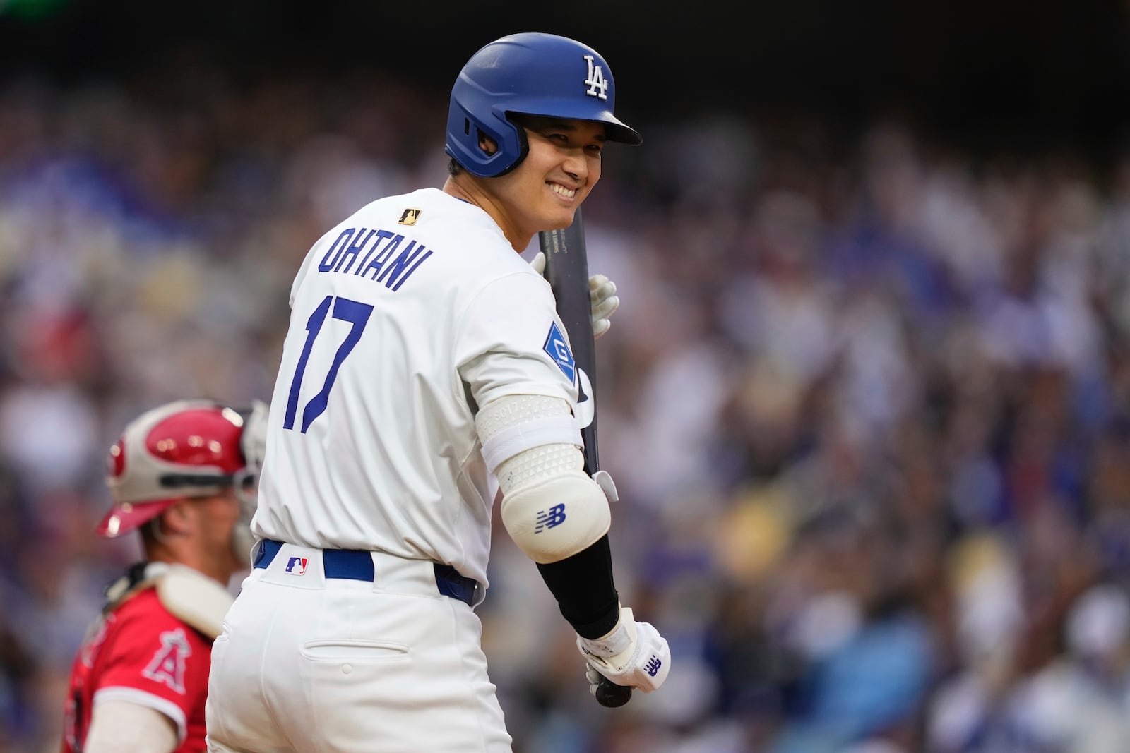 Los Angeles Dodgers' Shohei Ohtani smiles toward the Los Angeles Angels dugout as he steps up to bat during the first inning of a baseball game Saturday, May 17, 2025, in Los Angeles. (AP Photo/Mark J. Terrill)