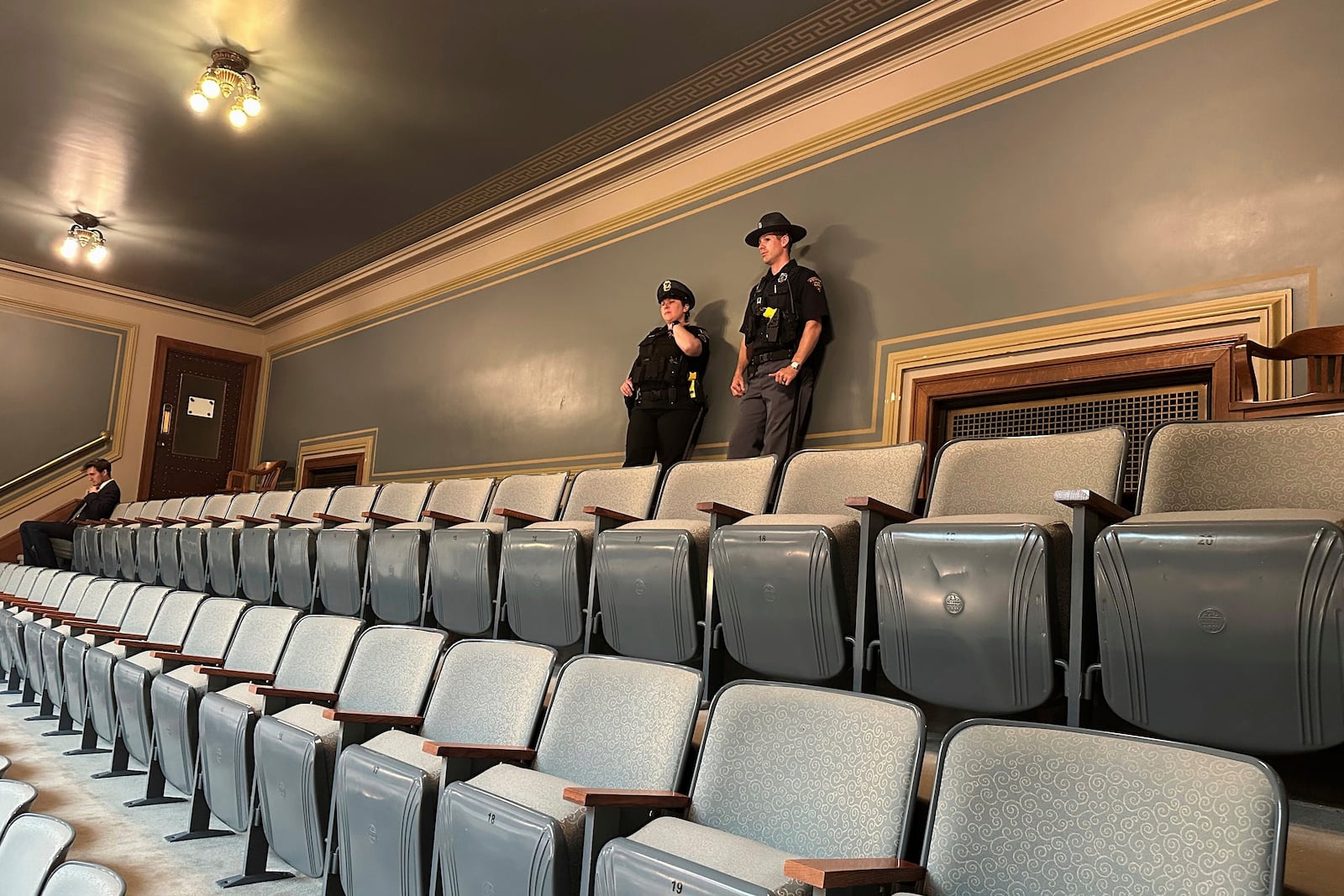 A Capitol police officer, left, stands with a Wisconsin state patrol officer at the top of the public gallery in the Assembly Chamber at the Wisconsin State Capitol in Madison, Wis., on Wednesday, June 18, 2025. (AP Photo/Scott Bauer)