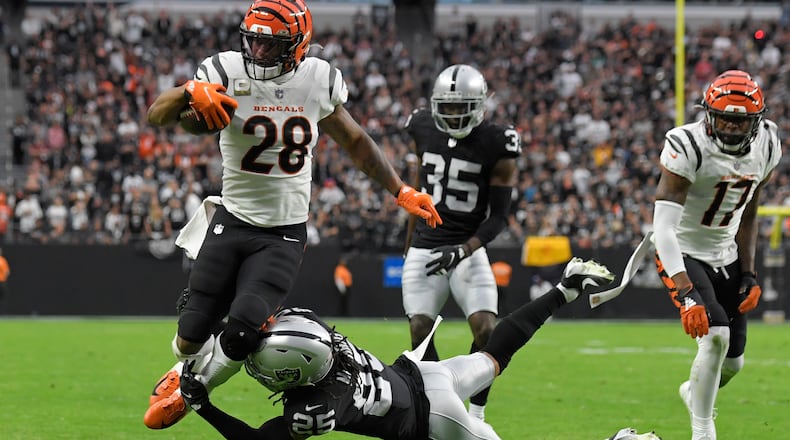 Cincinnati Bengals running back Joe Mixon (28) runs for a touchdown against Las Vegas Raiders free safety Trevon Moehrig (25) during the first half of an NFL football game, Sunday, Nov. 21, 2021, in Las Vegas. (AP Photo/David Becker)