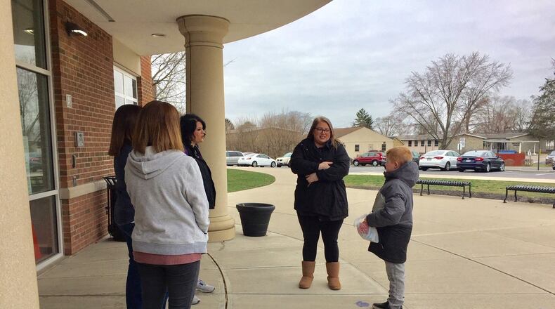 Middletown Schools were one of the first in the region to start handing out school meals to families Monday morning as the Butler County district started its state-ordered shut down due to concerns about the Coronavirus. School officials said the initial morning was slow but they expect participation to pick up as the week goes on. Here a mother and her child pick up free meals from Middletown’s Creekview Elementary. Other local districts are also giving away free meals, some starting later this week. (Photo By Michael D. Clark/Journal-News)