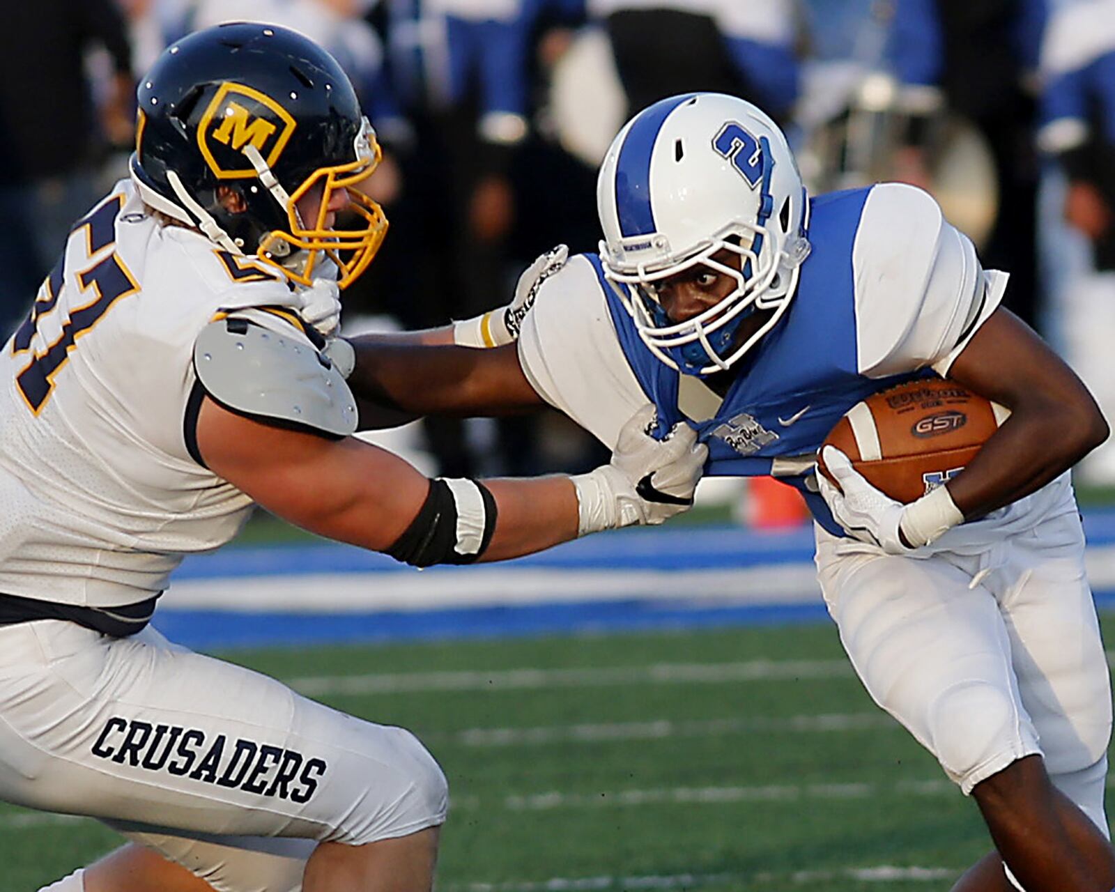 Hamilton’s DaQuan Maffett tries to get away from Moeller’s Ryan Mullaney during their Skyline Chili Crosstown Showdown game at Virgil Schwarm Stadium in Hamilton on Saturday night. CONTRIBUTED PHOTO BY E.L. HUBBARD