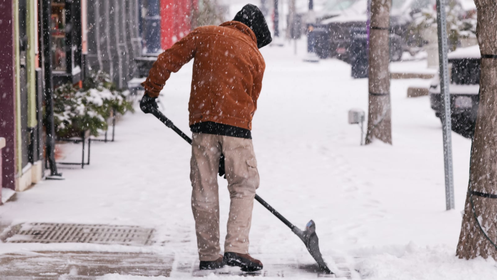 Several inches of snow fell around the Miami Valley on Dec. 13. Connor Watkins, an employee at Grandpa Joe's Candy Shop in downtown Troy, clears the sidewalk in front of the business on Saturday, Dec. 13. Up to six inches of snow was expected to fall in parts of the Miami Valley. BRYANT BILLING / STAFF