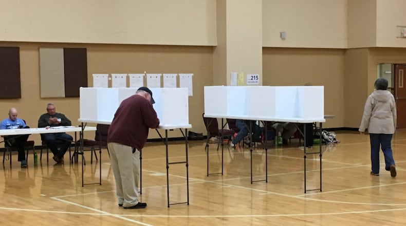 Dennis Young of Middletown cast his ballot at the Crosspointe Church of Christ on Tuesday. Young and other voters in six precincts at the polling place were relocated from Grace Baptist Church following a crash that damaged a utility pole and created a power outage. ED RICHTER/STAFF