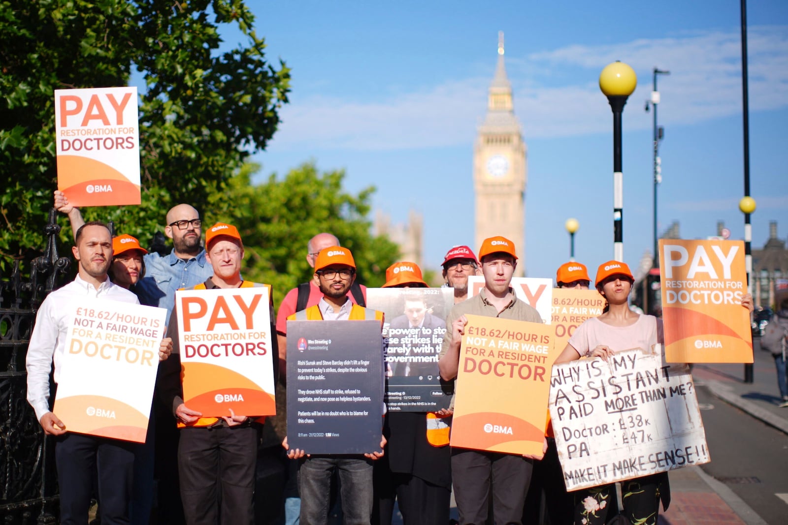 NHS resident doctors hold placards outside St Thomas' Hospital in London, as resident doctors in England, formerly referred to as junior doctors, begin a five-day strike after talks with the government collapsed over pay, Friday, July 25, 2025. ( James Manning/PA via AP)