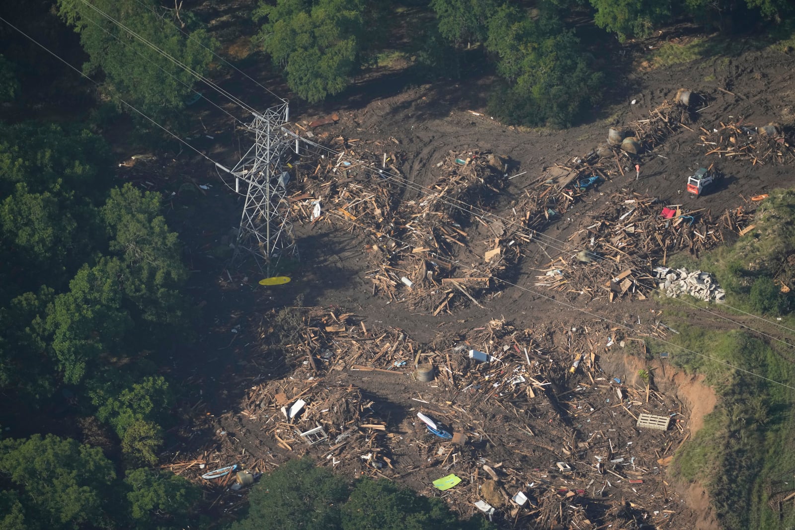 This aerial photo shows debris covering the ground in Hunt, Texas on Thursday, July 10, 2025. (AP Photo/Gerald Herbert)