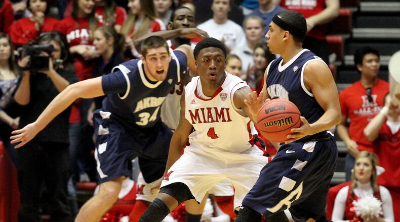 E.L. Hubbard photo Miami guard Reggie Johnson covers Akron guard Alex Abreu during their game at Millett Hall in Oxford Saturday, Feb. 9, 2013.