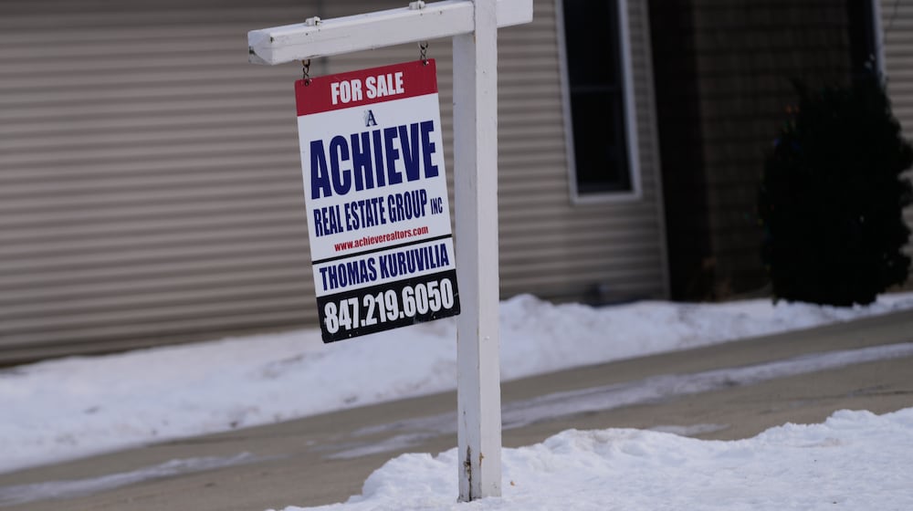 A "For Sale" sign is displayed in front of a home in Prospect Heights, Ill., Monday, Dec. 15, 2025. (AP Photo/Nam Y. Huh)