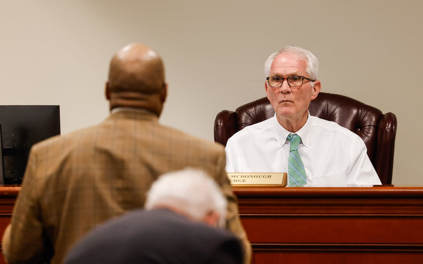 Butler County Area II Court Judge Kevin McDonough sits on the bench during the first docket day at the new location inside the old Hamilton municipal court at Butler County Government Services Center in Hamilton. Area I and Area II courts will work out of this courtroom. Judge McDonough is still waiting on a replacement robe after his was damaged in a fire at the historic Butler County Courthouse. NICK GRAHAM/STAFF